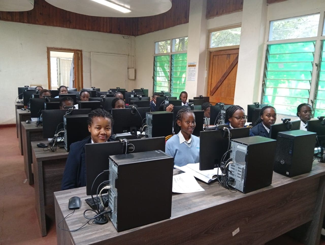 Pioneer girls learning at desktop computers in a computer laboratory