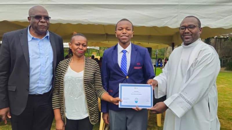 Pioneer student Ernest Wamae with his mother, a parent representative and Fr. Chege following his AI certification